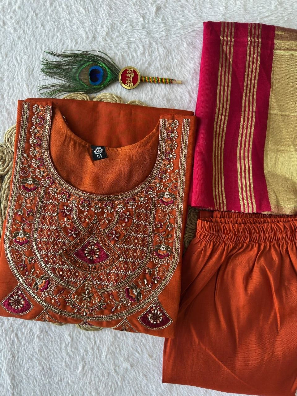 Rust kurta set with matching pants and embroidered neckline