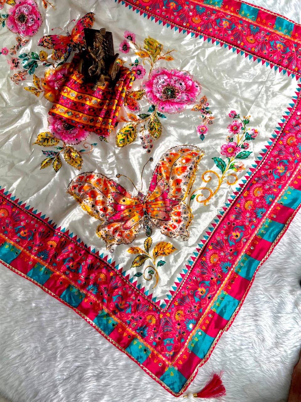 Ivory saree with pink turquoise border and butterfly motif