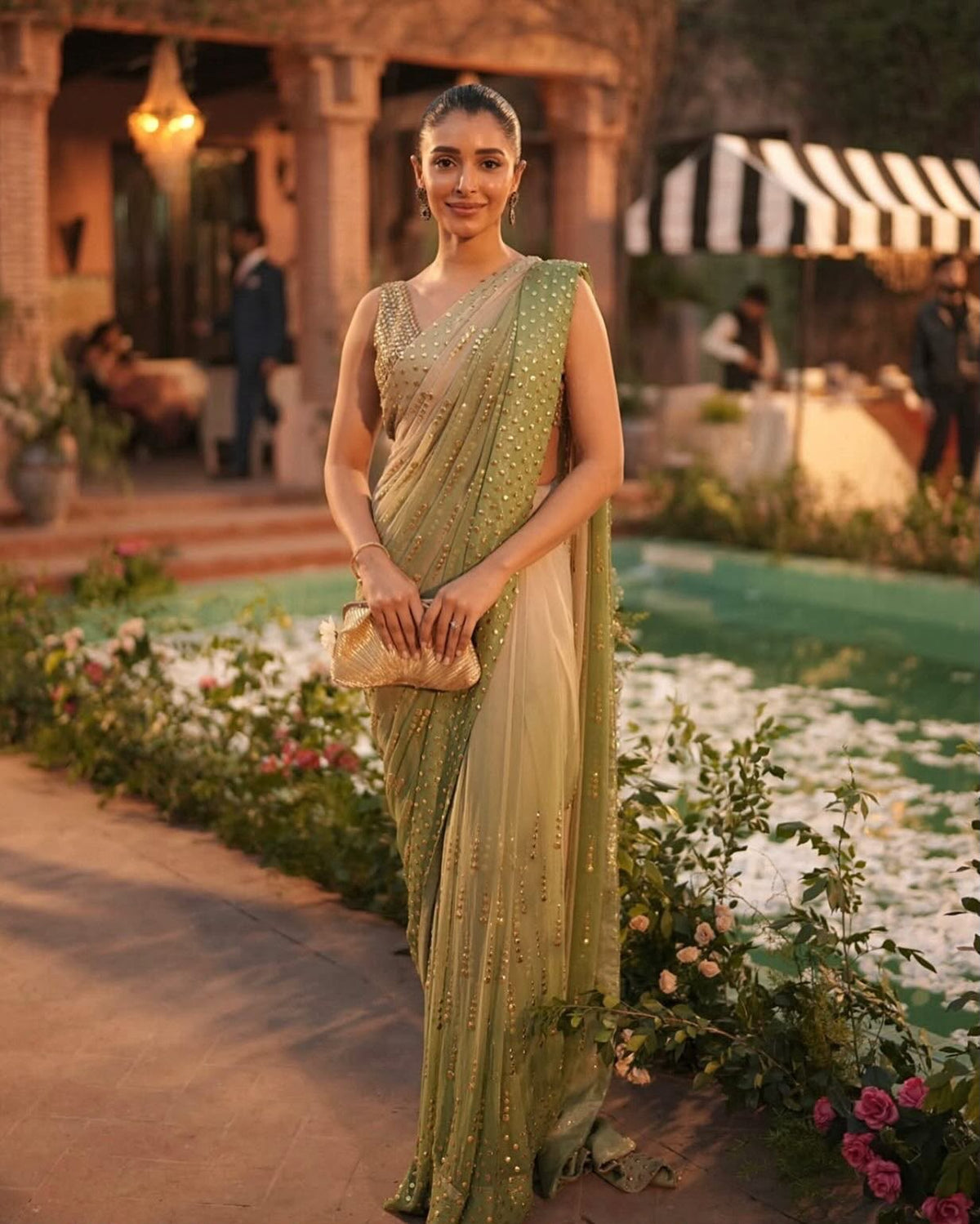Sage green designer faux georgette saree with foil work styled on model