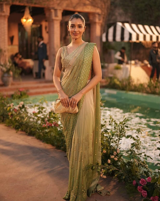 Sage green designer faux georgette saree with foil work styled on model