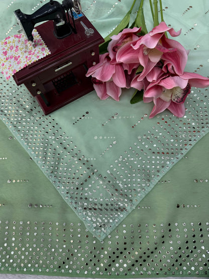 Close-up of foil embellishment on sage green faux georgette saree