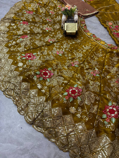 Close-up of olive brown fox georgette lehenga with gold embroidery and cutwork border