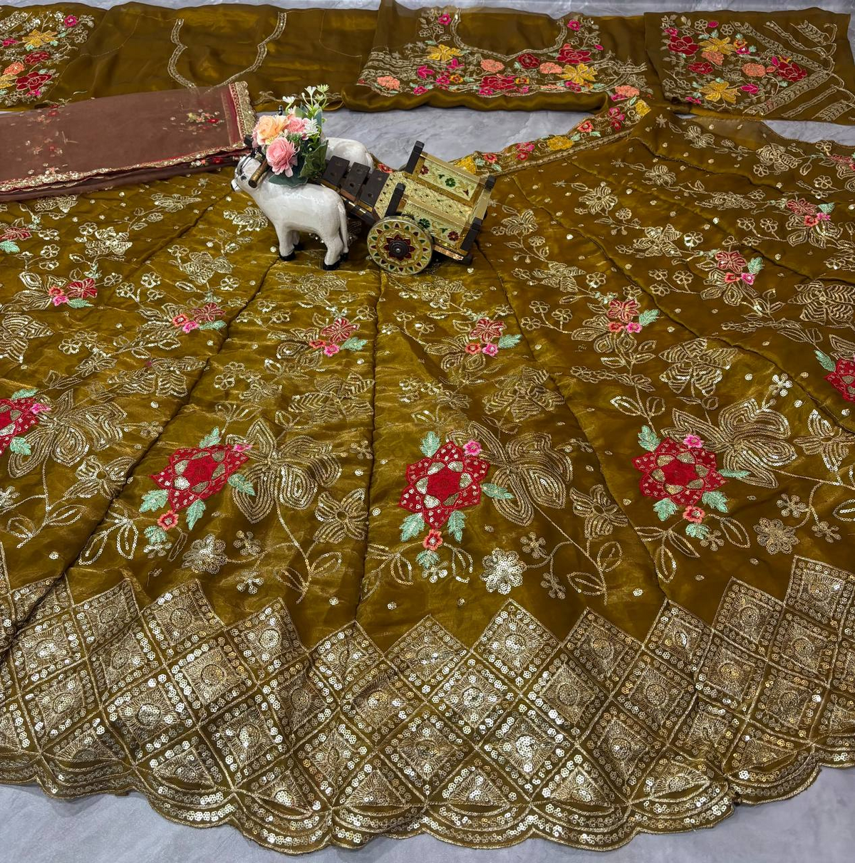 Full spread of olive brown sequins embroidered lehenga with ornate cutwork border