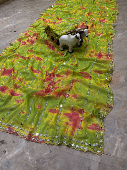Close-up of green saree mirror embellishments and border