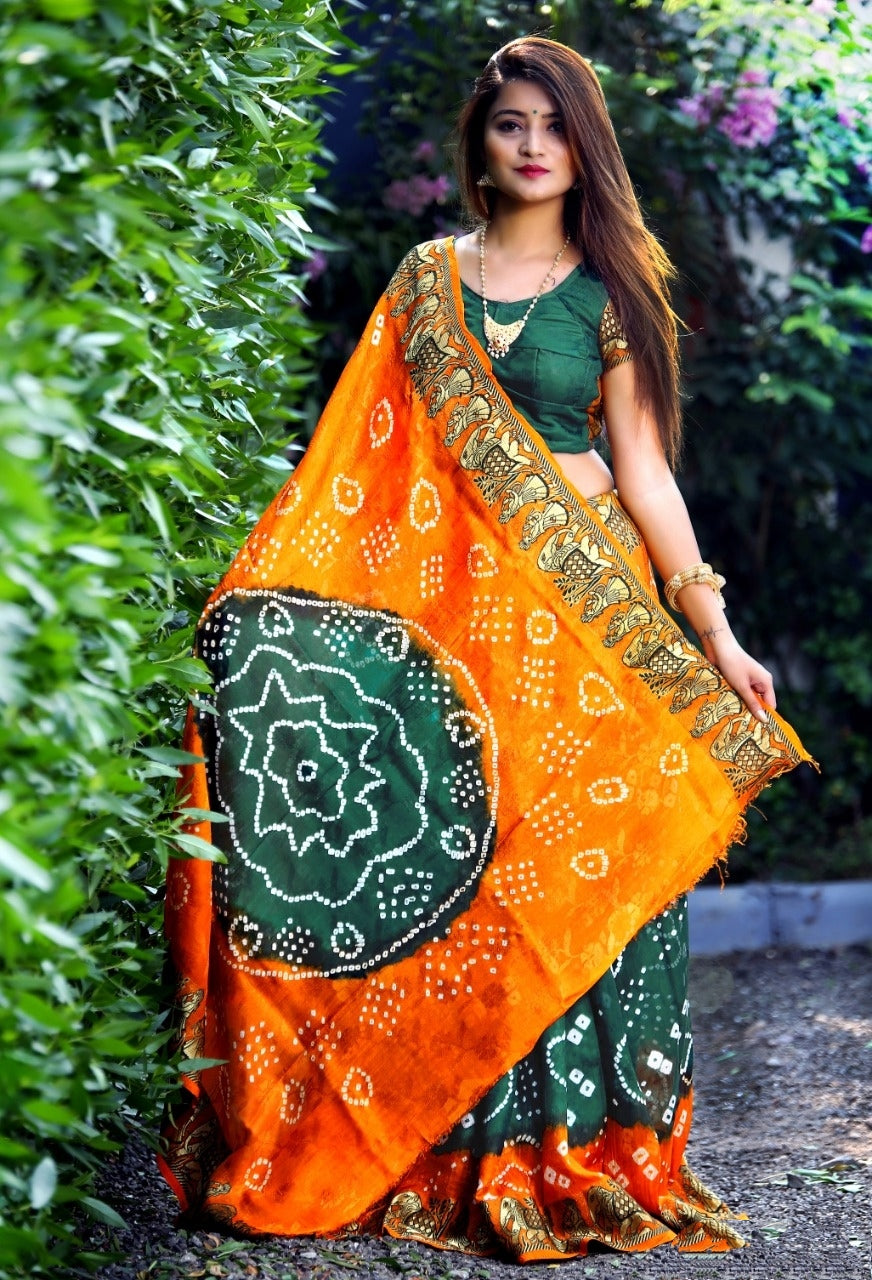 Phenomenal Orange & Dark Green Silk Bandhej With Zari Weaving Border Saree for Party Wear