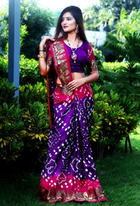 Breathtaking Rani & Purple Silk Bandhej With Zari Weaving Border Saree for Party Wear