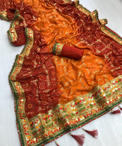 Comely Orange Georgette Bandhani Foil Work Print Mil Designer Saree Online