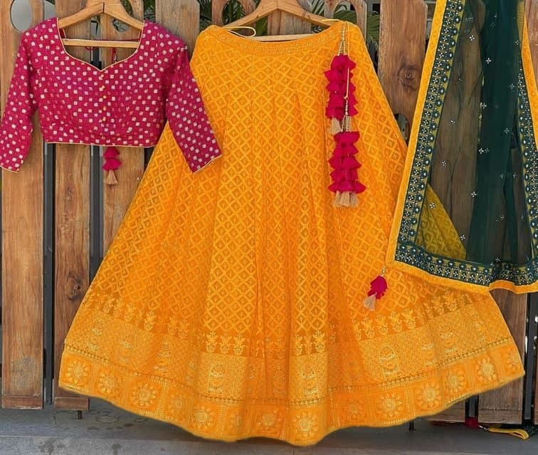 Shattering Mustard Color Net Lucknowi Embroidered Work Wedding Wear Lehenga Choli