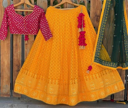 Shattering Mustard Color Net Lucknowi Embroidered Work Wedding Wear Lehenga Choli